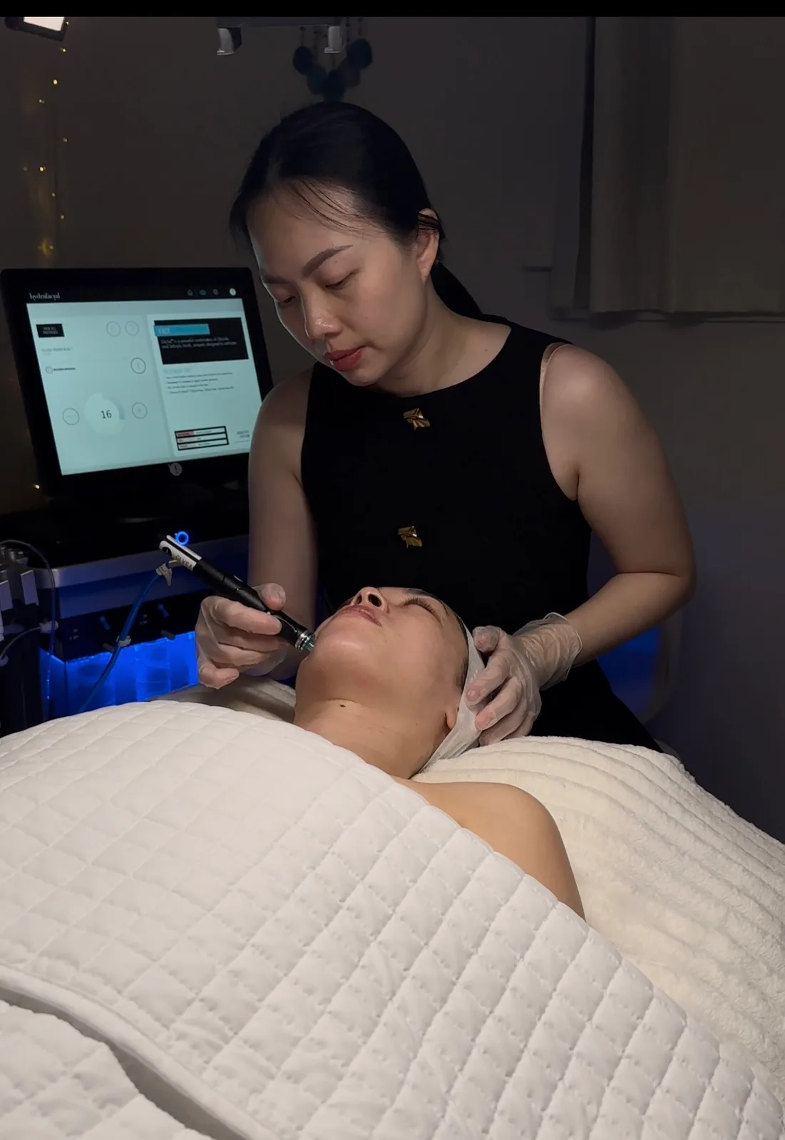 Phuong Dang, founder and licensed esthetician at SORA Skin & Ritual House, performing a HydraFacial treatment in Peoria, Arizona